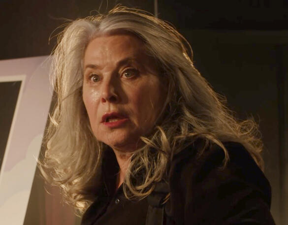 9 Dramatically lit close-up of Lorraine Bracco in shock on stage with long grey hair in Monster Summer.