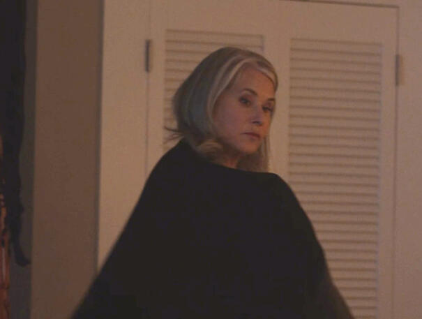 12 Lorraine Bracco looking over her shoulder wrapped in a black cloak in Monster Summer.
