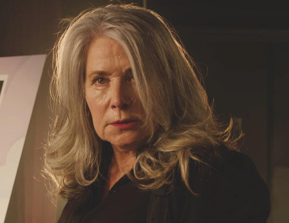 10 Close-up of a stern Lorraine Bracco on stage with long grey hair in Monster Summer.