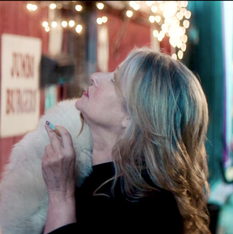 5 Lorraine Bracco in fur coat smoking looking up in Jacir.