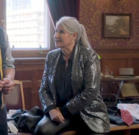 2 Actress Lorraine Bracco wearing a sequin jacket seated indoors in Jerk series.