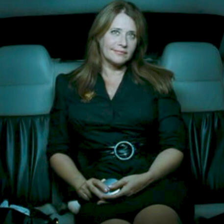 2 Actress Lorraine Bracco sitting in back of car smirking in Son of Morning.