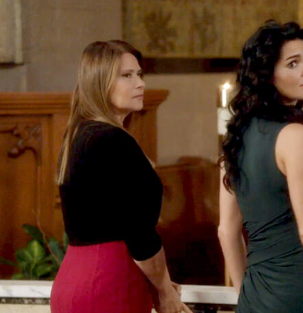 3 Angela Rizzoli played by Lorraine Bracco looking back over her shoulder at a christening.