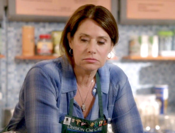 4 Lorraine Bracco as Angela Rizzoli wearing a green apron looking deflated in Rizzoli and Isles.