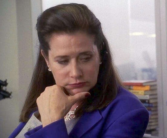 think Pensive Lorraine Bracco in a blue blazer on Lipstick Jungle TV show.