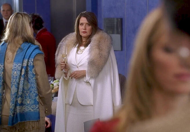 is Lorraine Bracco in an elegant white fur cape outfit on Lipstick Jungle.