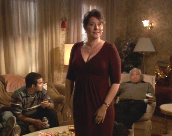 2 Actress Lorraine Bracco standing in a living room during a scene from the holiday film Snowglobe.