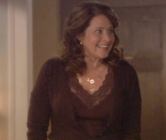 7 A smiling Lorraine Bracco wearing a necklace and a lace top from the movie Snowglobe.