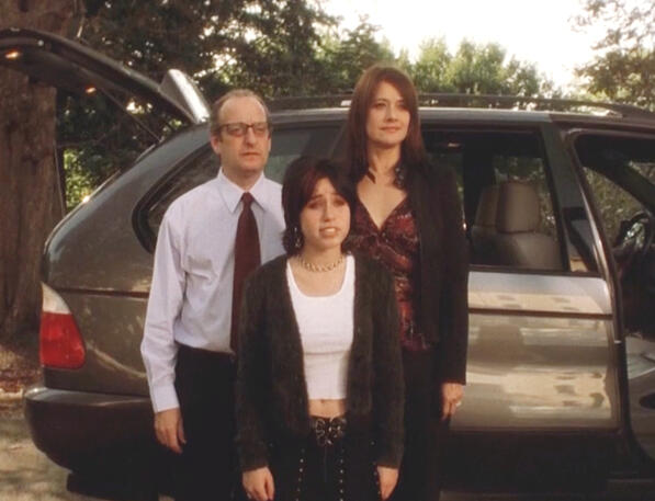 9 Lorraine Bracco standing with David Paymer and her daughter in front of an SUV in Crazy for Love.