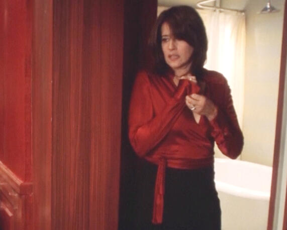 12 Lorraine Bracco looking anxious while holding her red wrap satin shirt in a Crazy for Love.