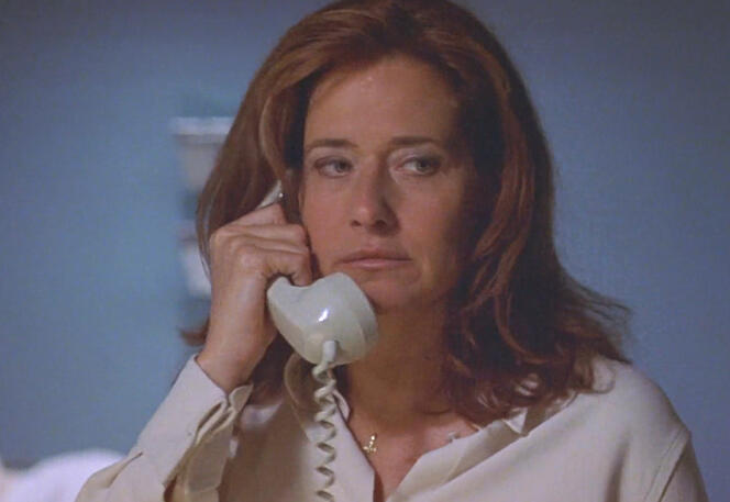 7 Lorraine Bracco holding a phone to her ear, in Tangled.
