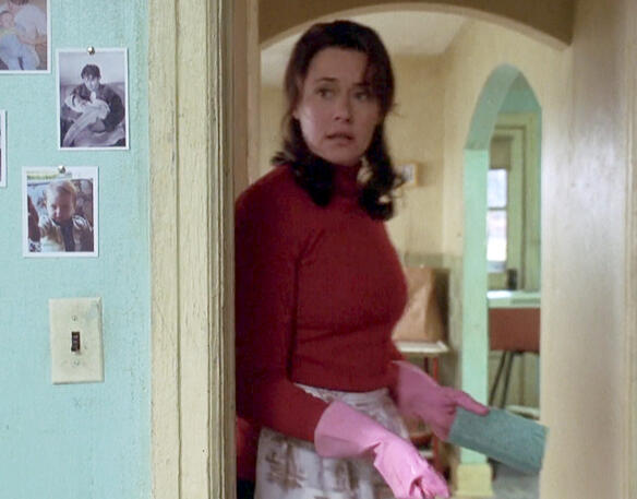 1 Lorraine Bracco in red turtleneck and pink cleaning gloves in Riding in Cars with Boys movie scene.