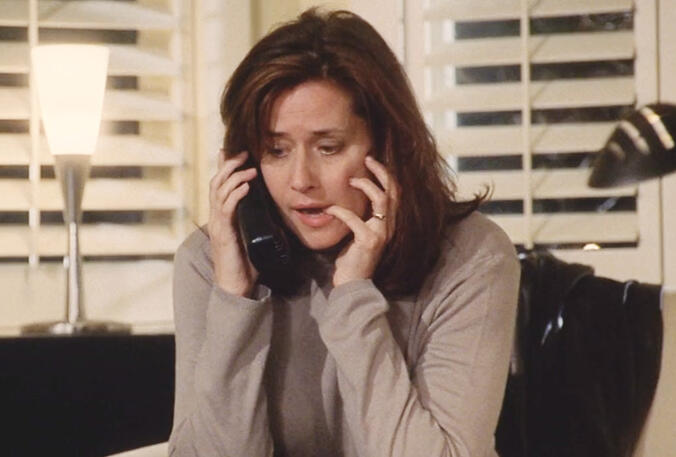 1 Lorraine Bracco looking anxious on the phone in a scene from Custody of the Heart movie.