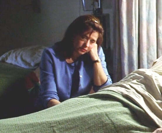 8 Lorraine Bracco looking sad while resting her head on her hand in Custody of the Heart.