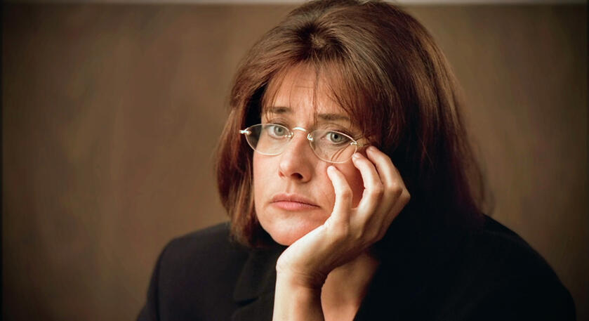 1 Lorraine Bracco as Dr. Jennifer Melfi looking bored with hand on chin in The Sopranos.