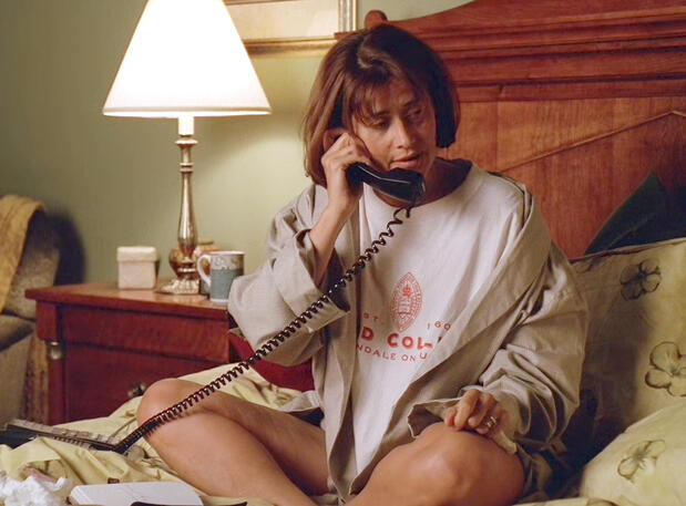 5 Jennifer Melfi sitting cross-legged on a bed talking to Carmela Soprano on a landline phone in The Sopranos.