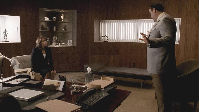 7 Tony Soprano all suave in a suit standing and gesturing towards Dr. Melfi in The Sopranos.