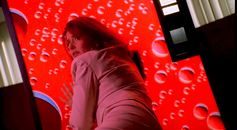 9 Dr. Melfi in a cream suit looking frightened as she's stuck in a vending machine in The Sopranos.