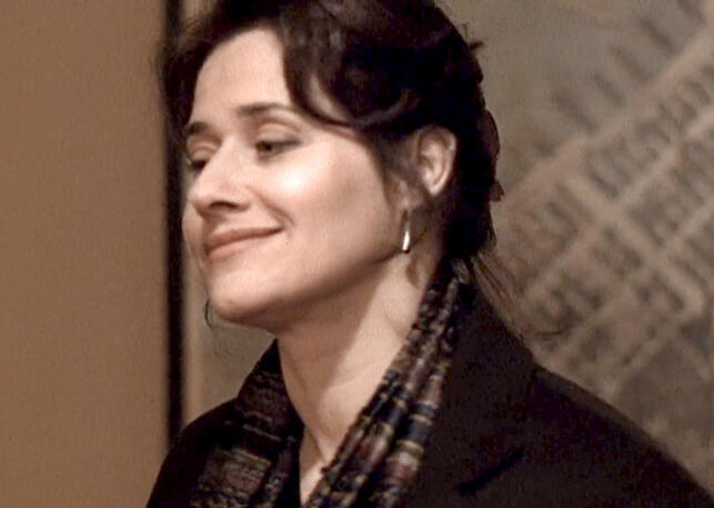 3 Lorraine Bracco smirking big in a black coat and scarf in The Taking of Pelham 1 2 3