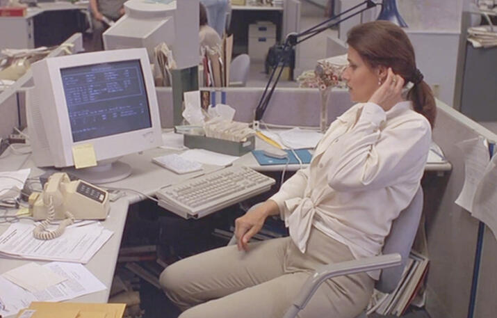 8 Lorraine Bracco sitting at a computer desk office desk in Silent Cradle.