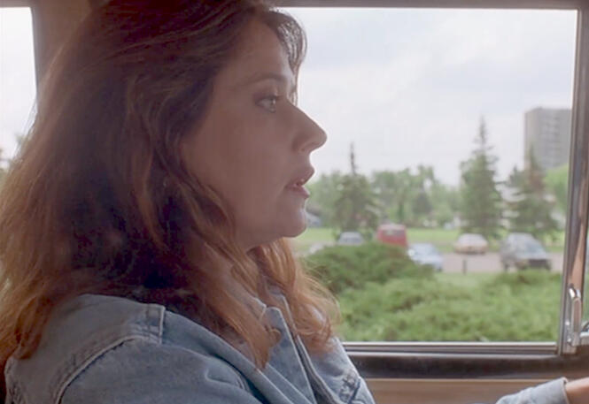 9 Lorraine Bracco side profile while looking shocked in her car in Silent Cradle.