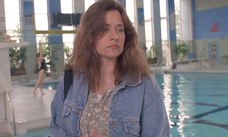 11 Lorraine Bracco in a denim jacket standing by a pool in Silent Cradle.