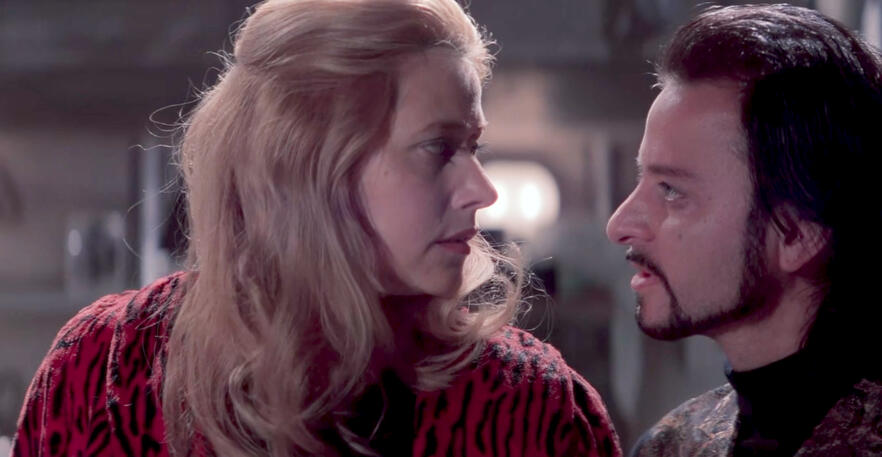 12 Side profile of Lorraine Bracco talking to Fisher Stevens in a scene from the movie Hackers.