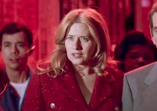 10 Lorraine Bracco in a red blazer with a confused expression in a crowd scene from Hackers.