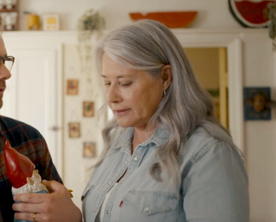 2 Actress Lorraine Bracco in a denim shirt looking down in The Mother, the Menacer, and Me.