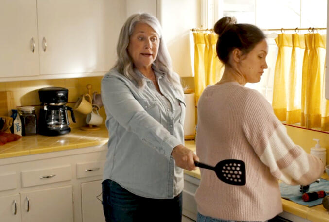 7 Lorraine Bracco pointing with a spatula in kitchen from The Mother, the Menacer, and Me.