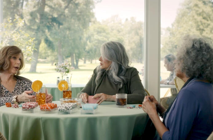 8 Lorraine Bracco sitting with friends playing a game in The Mother, the Menacer, and Me.