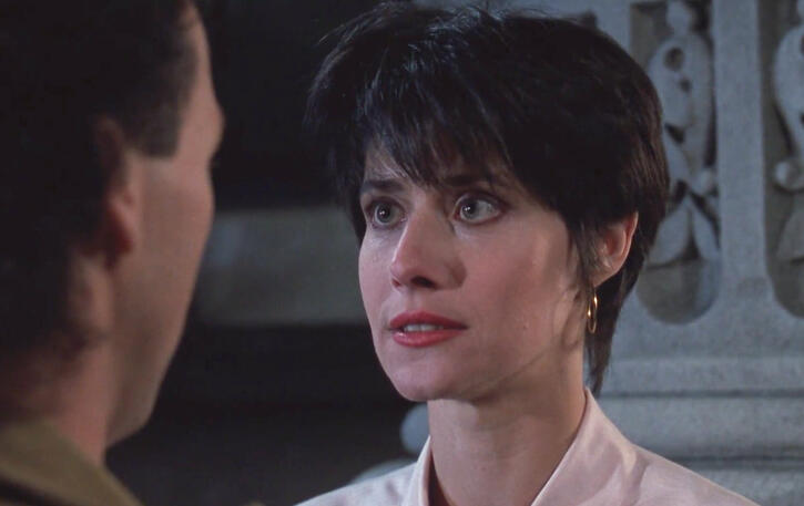 6 Lorraine Bracco closeup talking to Michael Keaton in The Dream Team film.