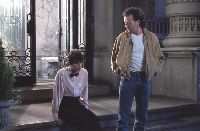 5 Lorraine Bracco sitting on steps next to Michael Keaton, The Dream Team.
