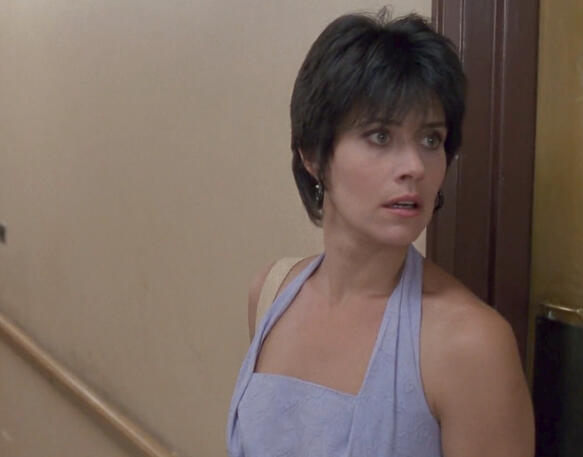 9 Lorraine Bracco looking startled near a doorway in The Dream Team.