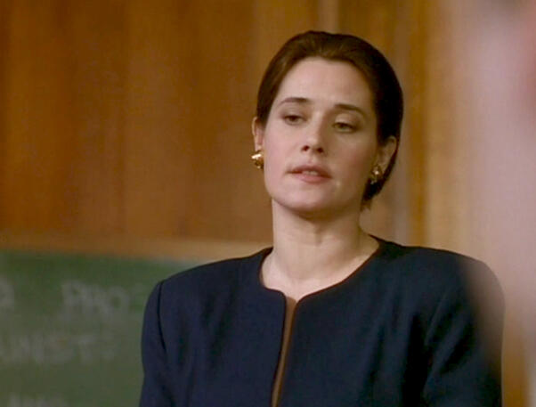 9 Lorraine Bracco wearing a dark blue blazer in a meeting room from Getting Gotti.