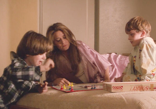 4 Lorraine Bracco playing the game Sorry! on a bed with young Elijah Wood and Joseph Mazzello in the movie Radio Flyer.