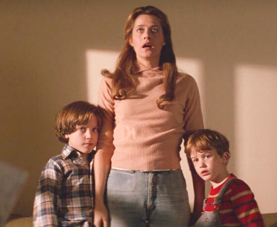 11 Lorraine Bracco looking shocked while standing between Elijah Wood and Joseph Mazzello in the movie Radio Flyer.