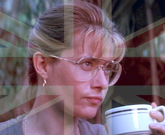 6 Lorraine Bracco with glasses drinking from a mug with Union Jack meme overlay, in Medicine Man.