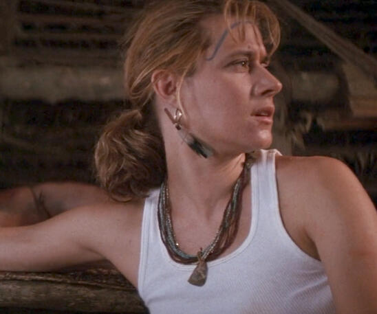 8 Lorraine Bracco looking to the side wearing a white tank top in Medicine Man.