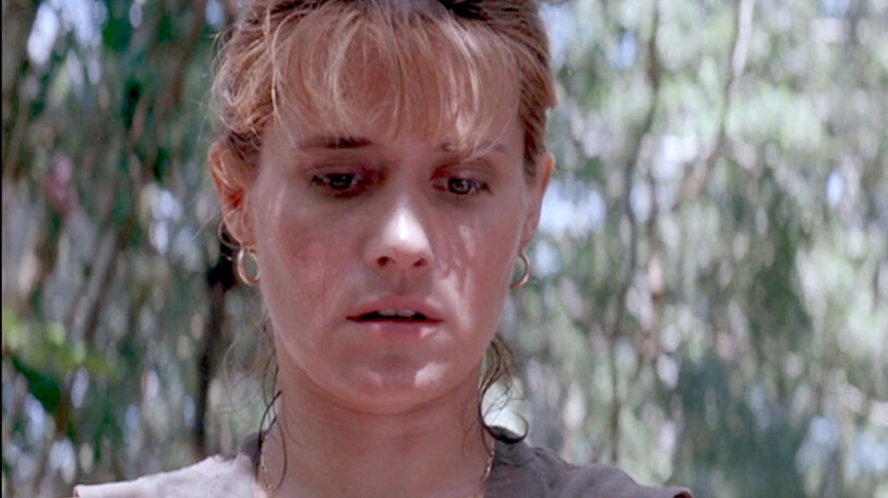 12 Close-up of a sweating Lorraine Bracco looking downcast in Medicine Man jungle.