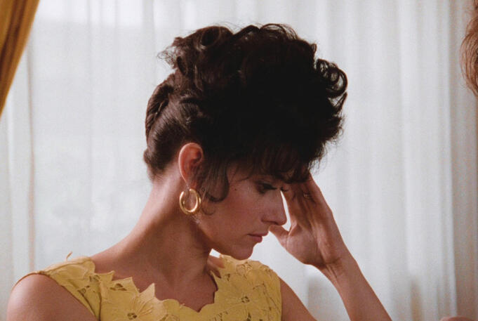 2 Lorraine Bracco as Karen Hill looking stressed with hand to head in a yellow dress in Goodfellas.