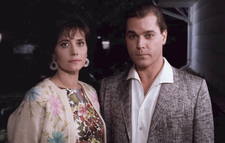 8 Lorraine Bracco and Ray Liotta standing together looking at Karen's mother in a scene from Goodfellas.