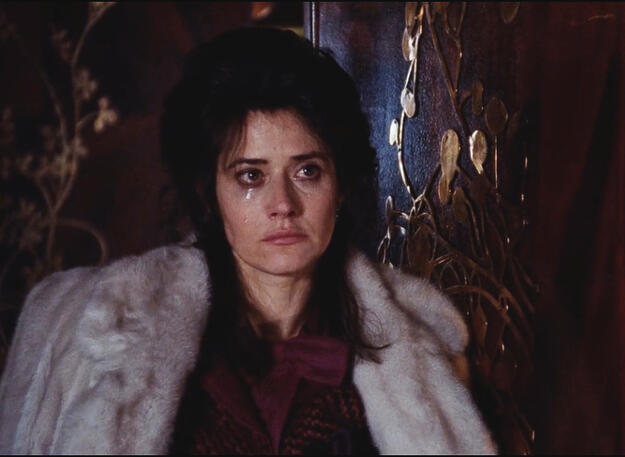 7 Close-up of a tearful Lorraine Bracco as Karen Hill in a white fur coat looking sad.