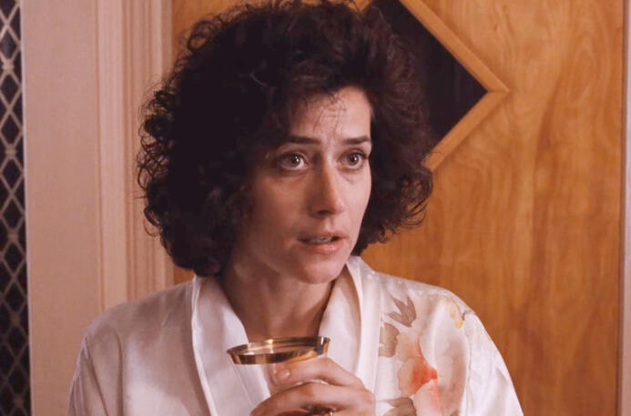 a hat...? Close-up of Lorraine Bracco holding a glass with a concerned expression in Goodfellas.