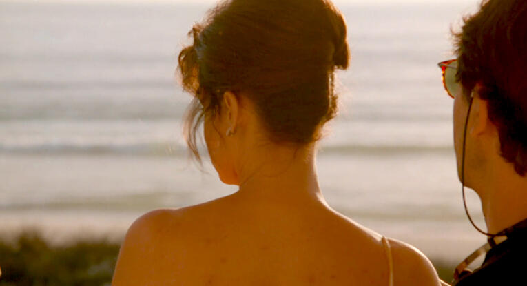 3 Lorraine Bracco from behind looking at the ocean beach in Les Menteurs.