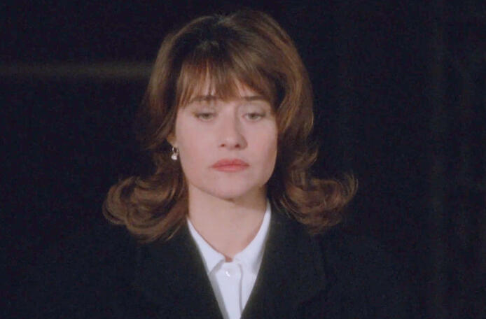 6 Lorraine Bracco looking down thoughtfully in a black coat in Les Menteurs