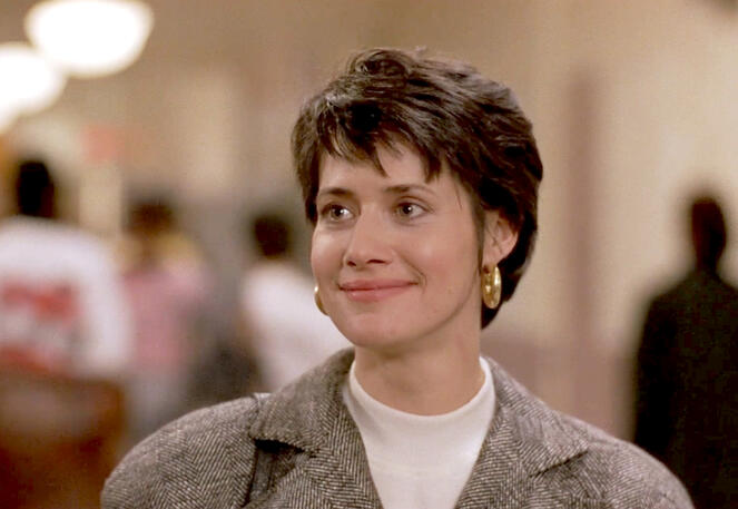 6 Lorraine Bracco smiling with gold hoop earrings as Miss Lombardo in Sing 1989 film.