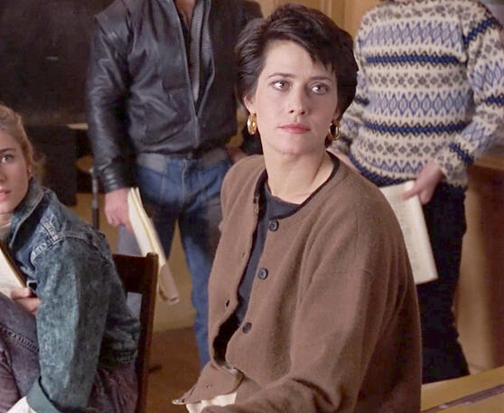 12 Lorraine Bracco sitting in a brown cardigan jacket looking serious in the movie Sing 1989.