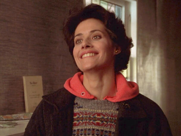 3 A smiling Lorraine Bracco in a patterned sweater and coat from Someone to Watch Over Me.