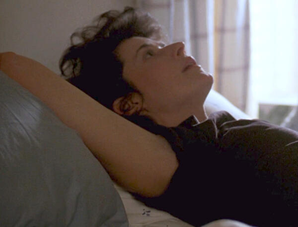4 Lorraine Bracco lying down and looking up in the film Someone to Watch Over Me.